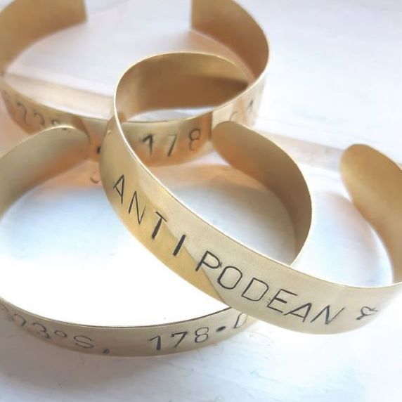 Brass cuff bracelet stamped with word Antipodean