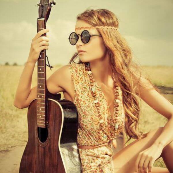 bohemian hippy girl with guitar and long beads